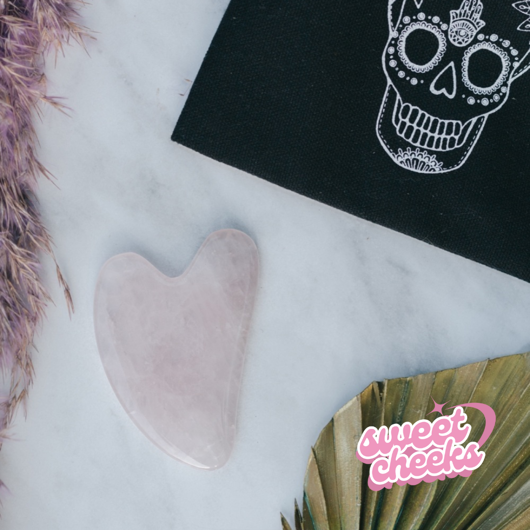 Rose Quartz Crystal Gua Sha with Black Skull Pouch - Sweet Cheeks